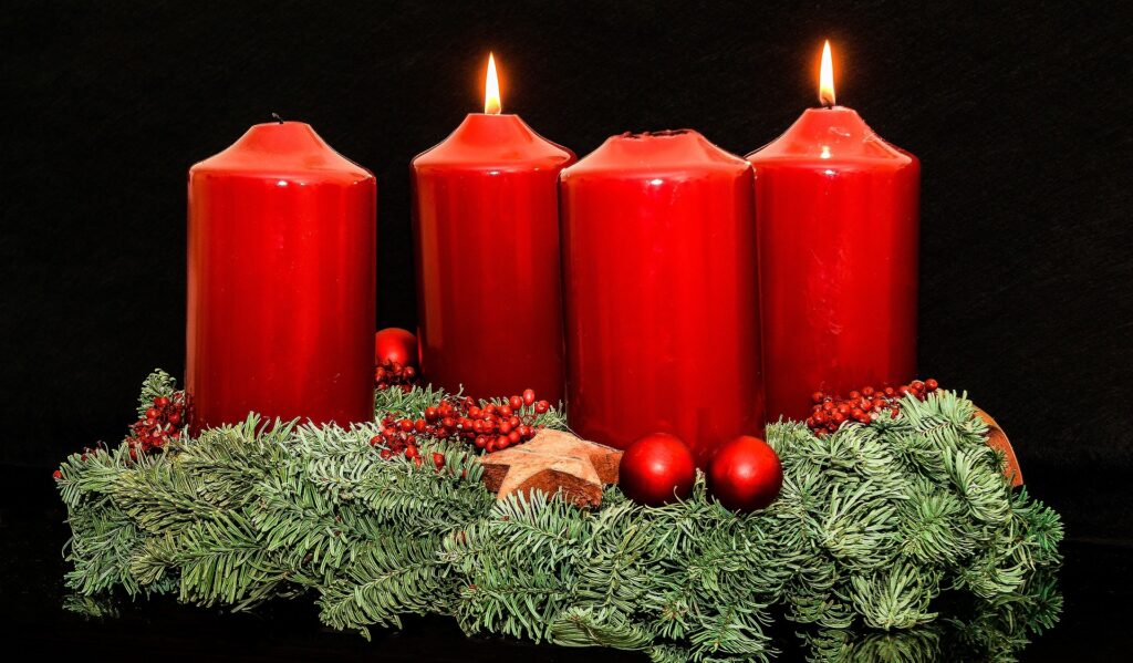 Advent wreath with four red candles only two of which are burning